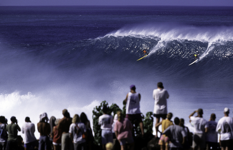 Image: Sharing at Waimea Bay is easy when the wave spans the area of a footy oval. Source: Stock / tropicalpixsingapore.